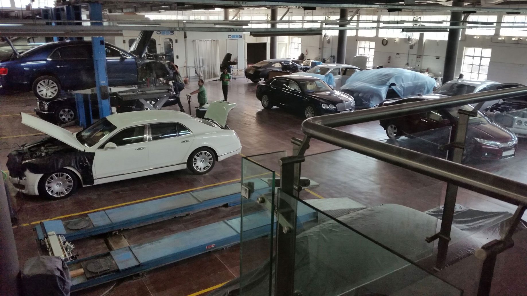 Installation of three blue Ravaglioli 2-post lifts in an authorised Bentley workshop