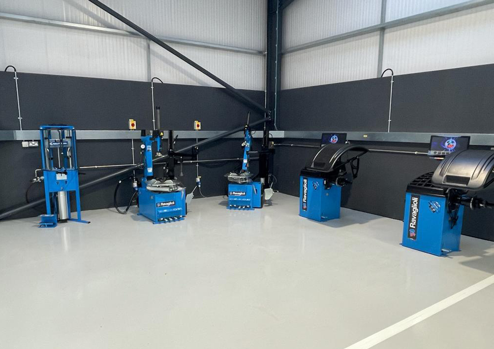 Ravaglioli hydraulic press, balancers, and tyre changers positioned in a corner